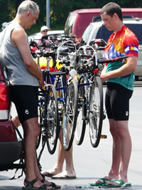 TRIRI riders adjusting bikes on a rack